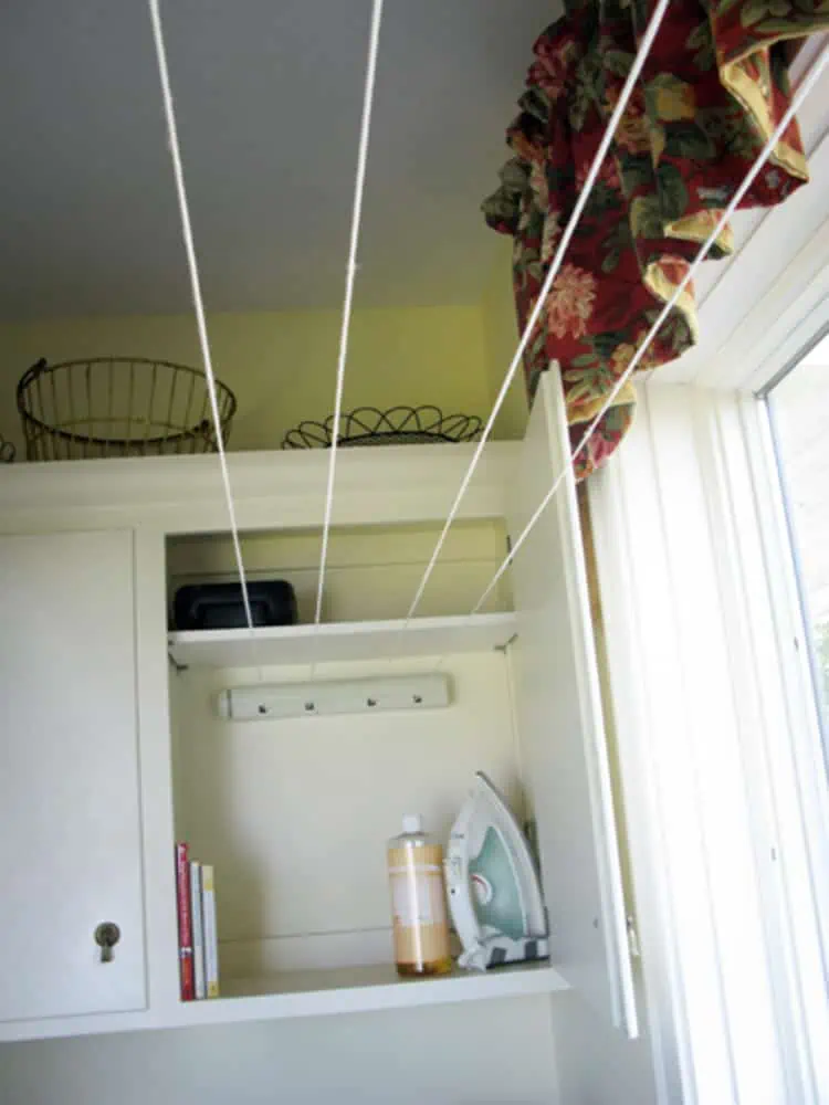06 - a clothesline installed in a cabinet next to a window and can folded in when not in use