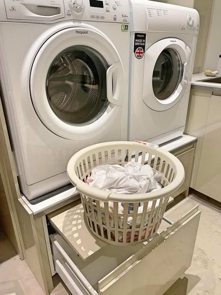 pedestal drawers under washer and dryer with additional pull-out shelves to put laundry baskets or supplies on