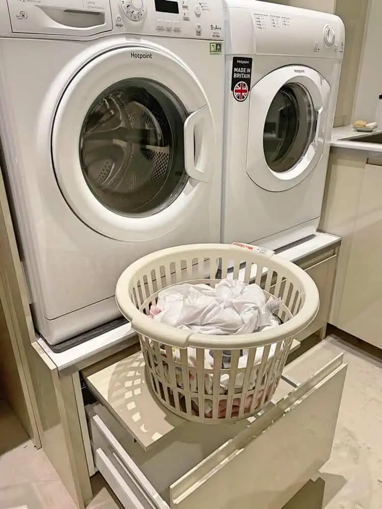 pedestal drawers under washer and dryer with additional pull-out shelves to put laundry baskets or supplies on