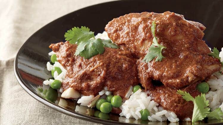 Slow Cooker Chicken Mole on rice with peas and parsley
