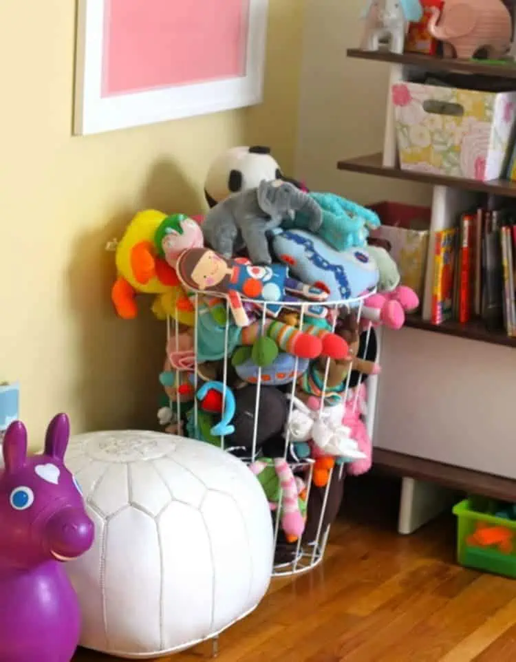 wire hamper used for stuffed animal storage in a kids room next to it