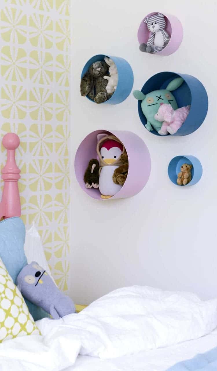 stuffed toys storage in hat boxes mounted on walls with different plush animals in them