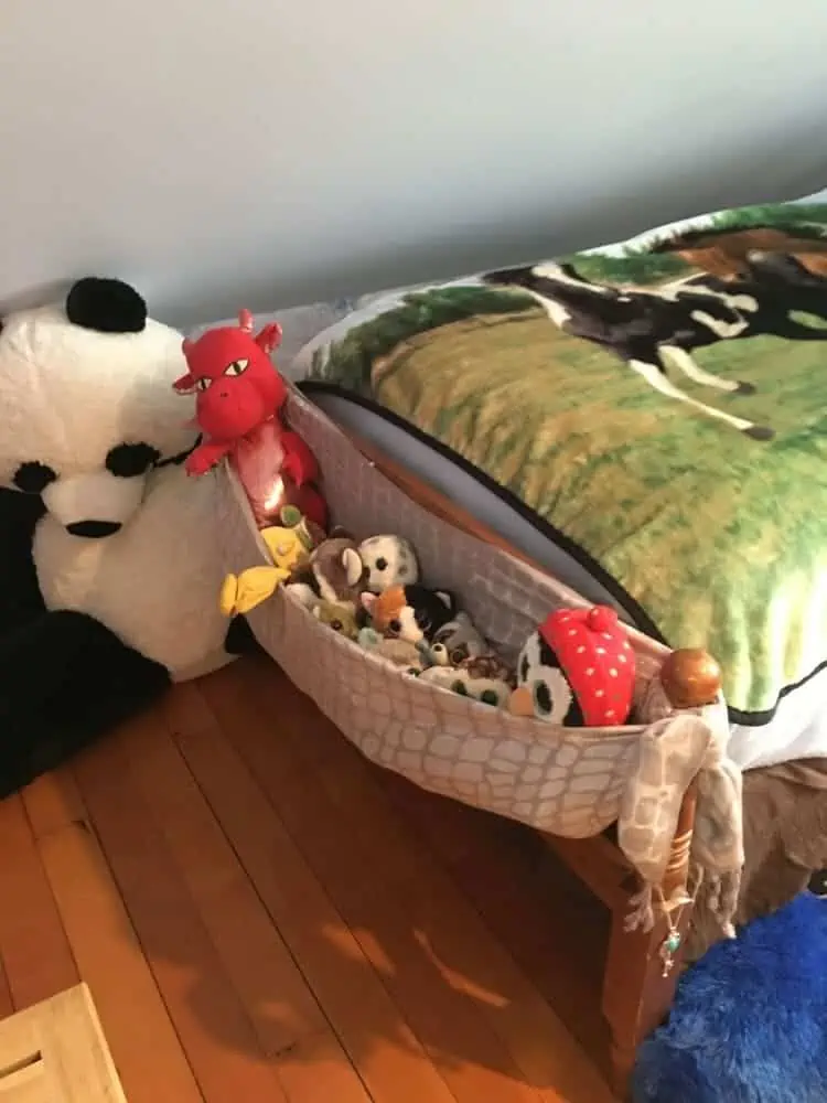 Scarf tied on the end of the bed as a pocket to hold stuffed animals