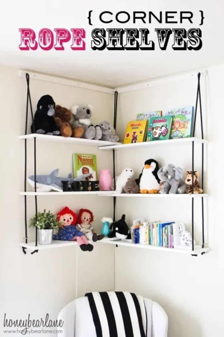 DIY corner rope shelves in a kids room with stuffed toys, small books, plants, etc