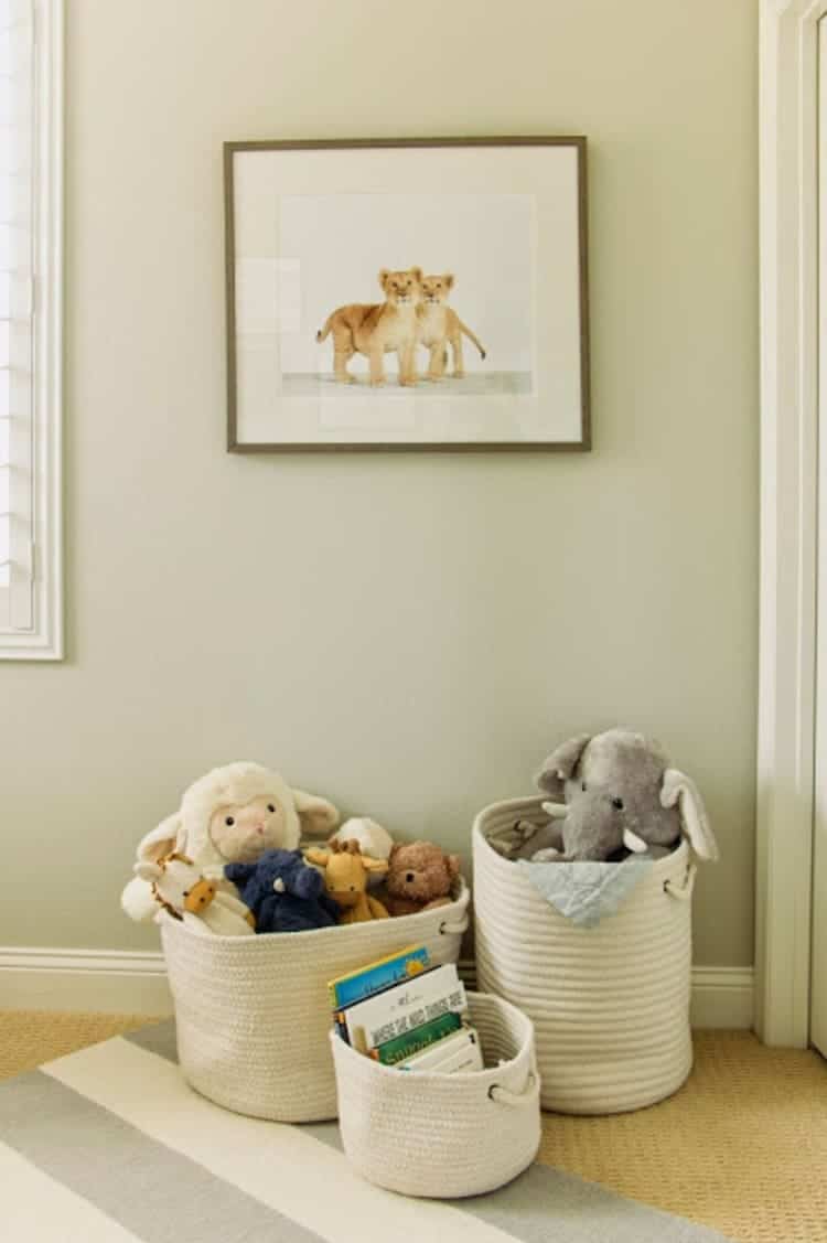 white fabric baskets with rope handles full of stuffed animals and books