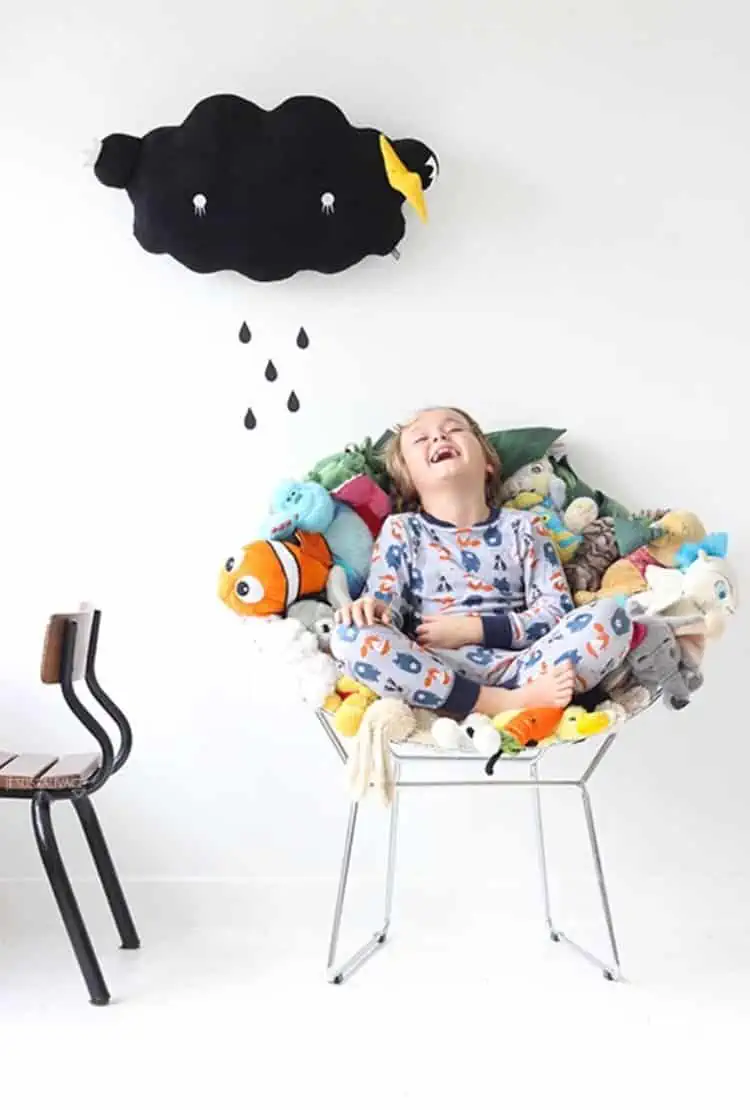 a chair from plush toys how to store stuffed animals with a boy sitting on the chair laughing