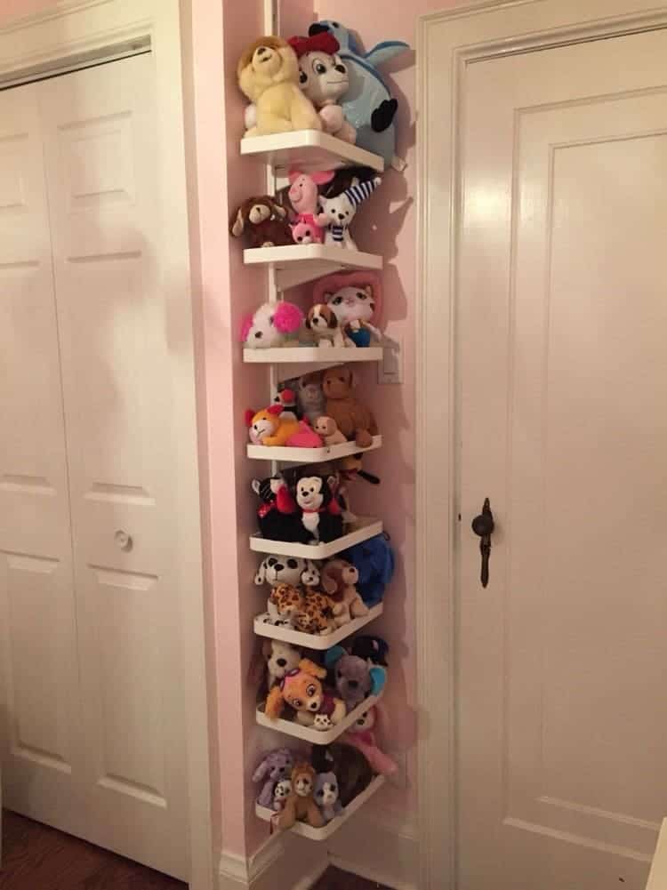 ikea algot shelves used as stuffed animals storage in a corner of a kids room
