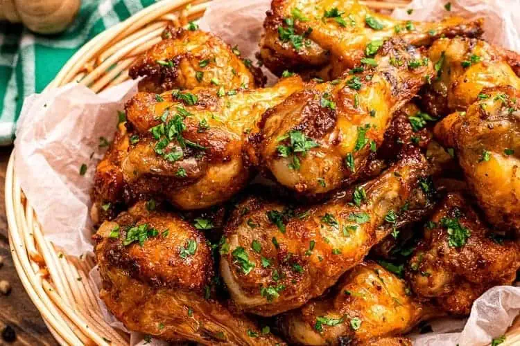 Frozen chicken wings air fryer recipe served sprinkled with greens