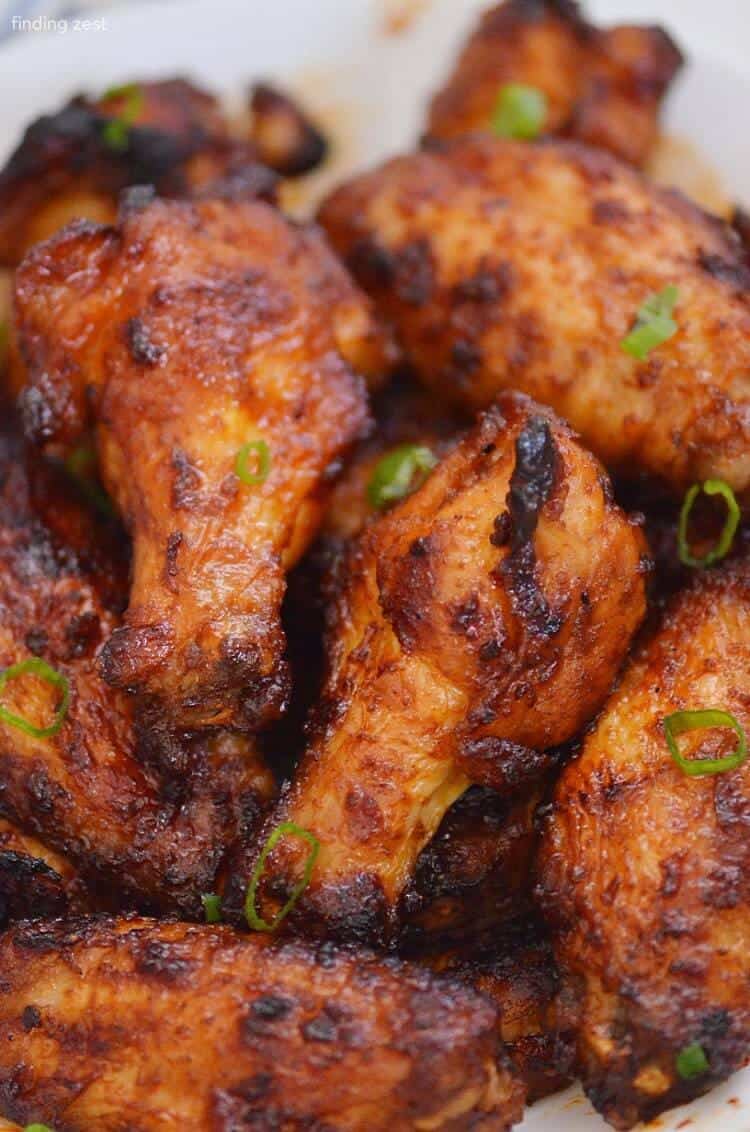 Air Fryer Wings Dry Rub BBQ Sauce sprinkled with greens close photo
