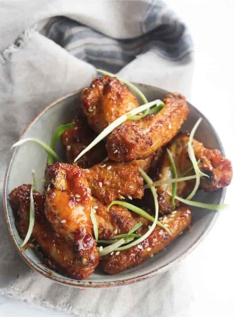 crispy chicken wings air fryer recipe served in a bowl with zoodles