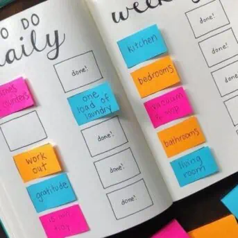 bullet journal with daily and weekly to-do list with post-it notes