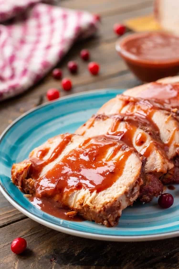Cranberry Crock Pot Pork Loin with sauce sliced and served in a plate