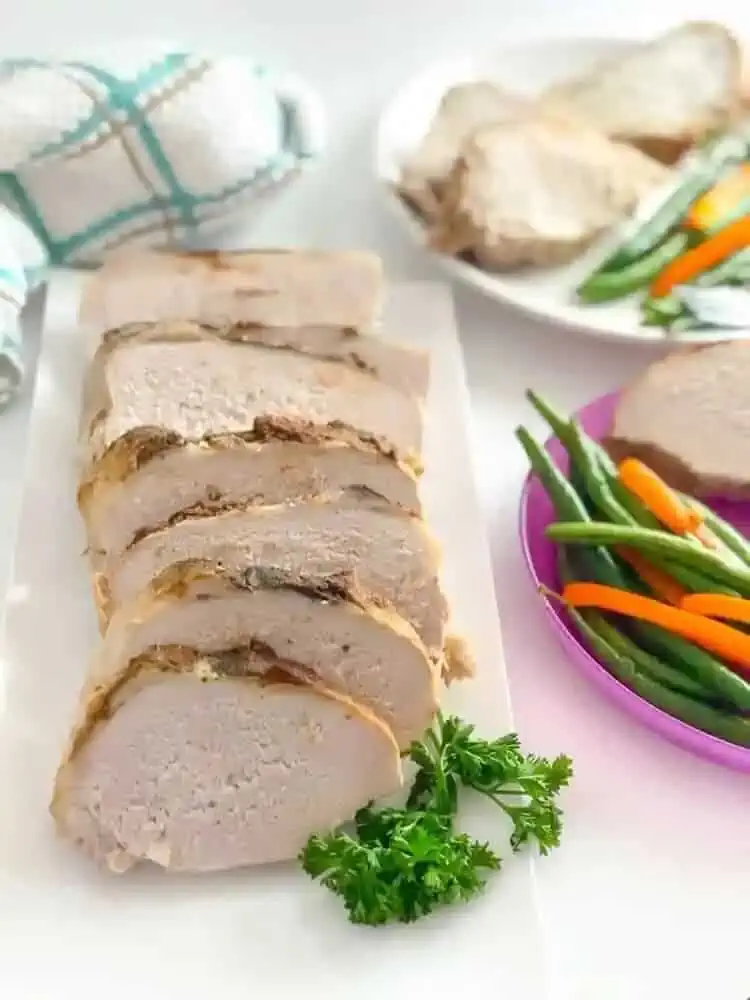 Lean Crock Pot Pork Loin Dinner Recipe close photo cut in pieces served with peppers