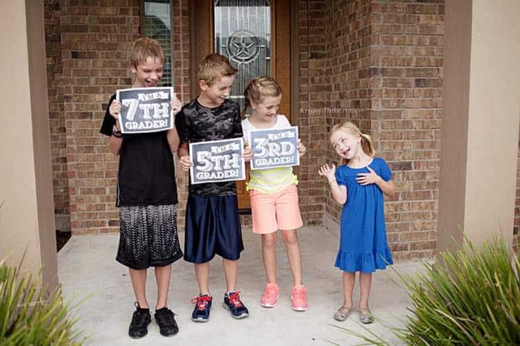 kids holding their back to school signs