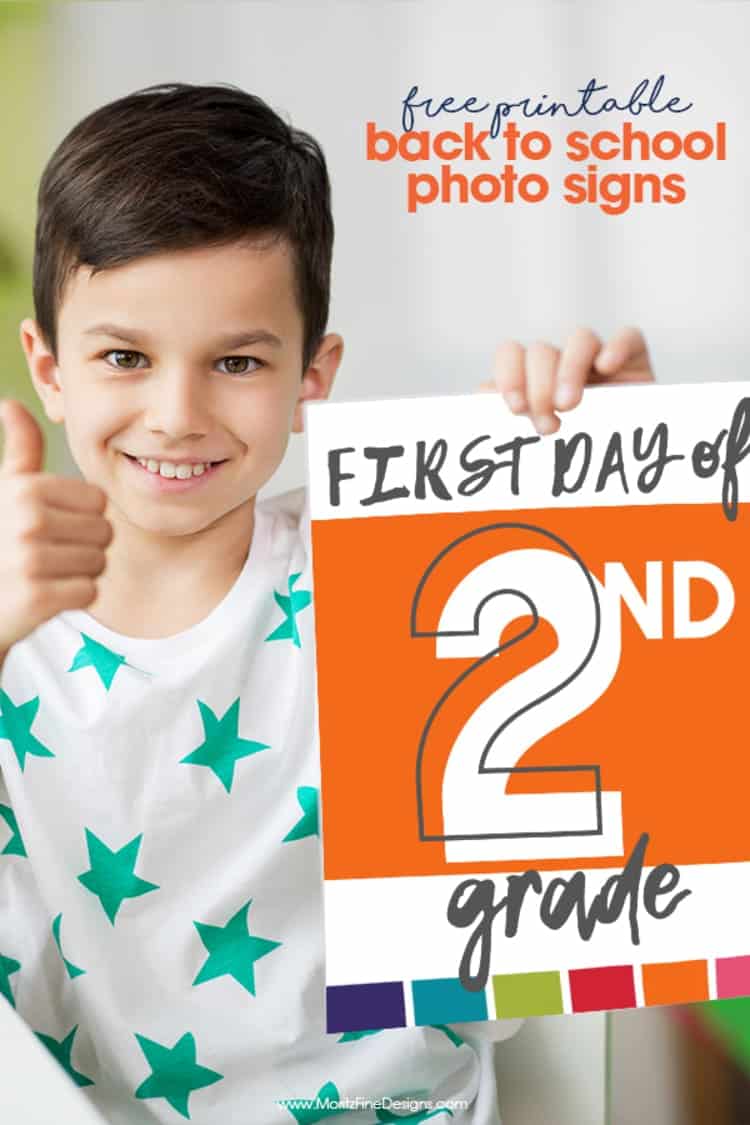 a boy doing thumbs up and holding a First Day of School Photo Sign for second grade