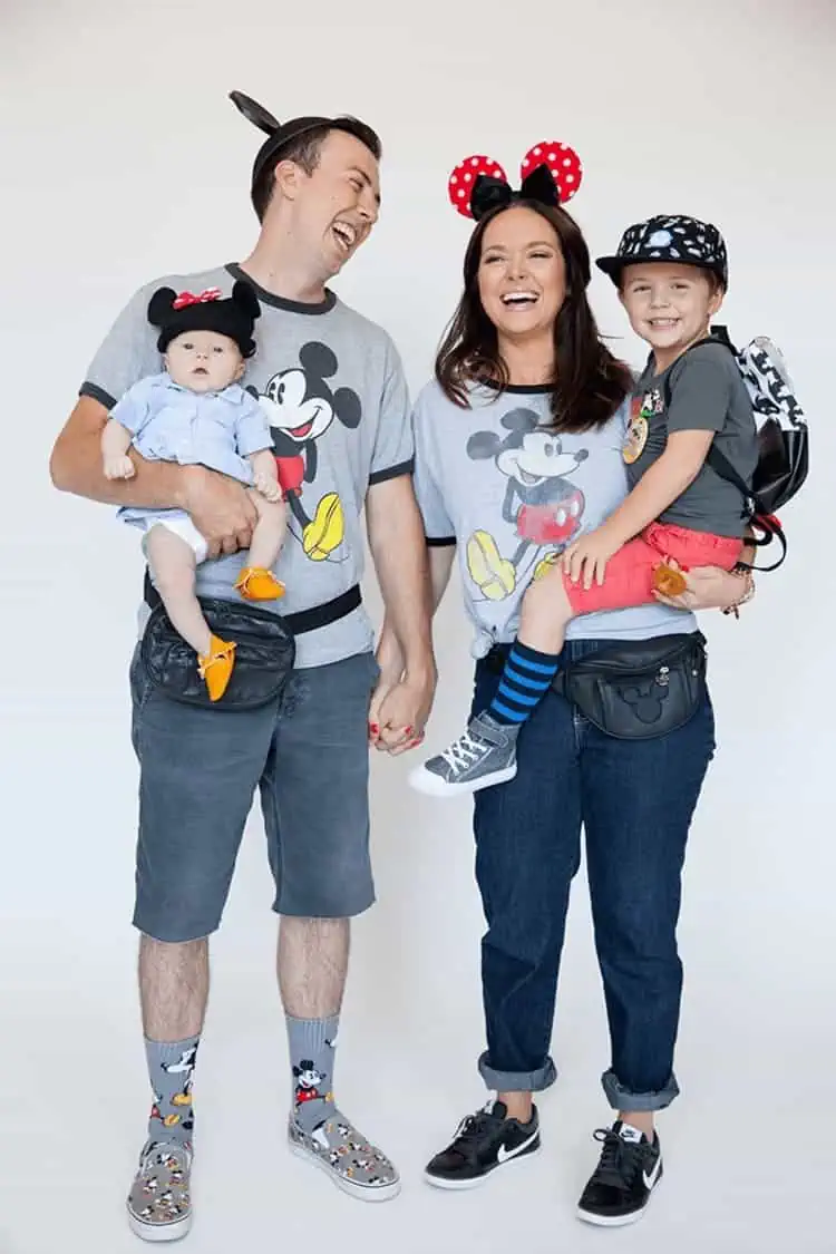 Halloween Family Costumes Disneyland Tourists family laughing dad holding baby mom a toddler