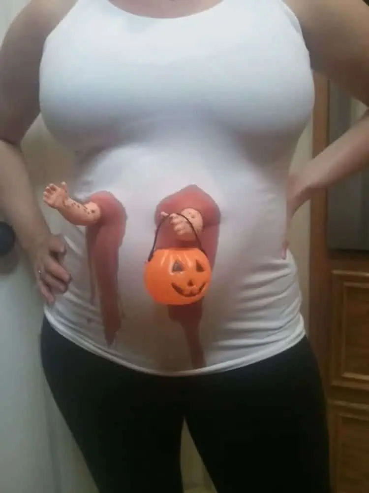 Ultimate Pregnant Mom Costume doll hands holding a treak or treat basket