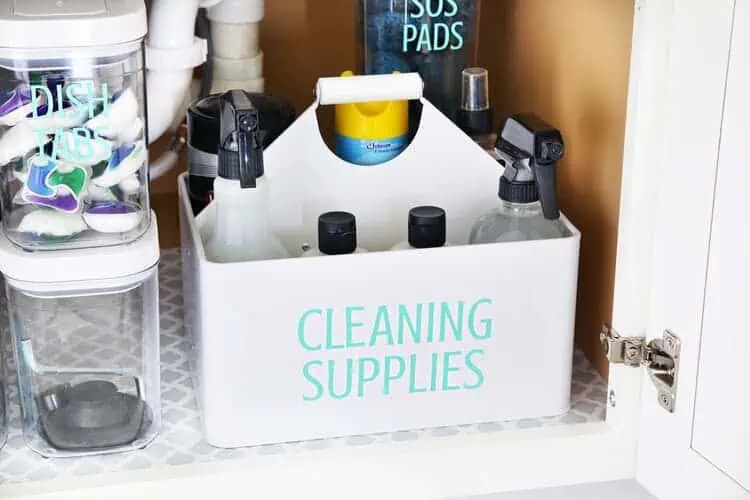 organizing under the kitchen sink with a cleaning caddy