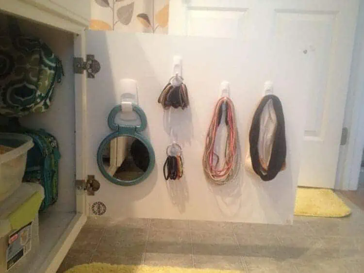 https://www.happyorganizedlife.com/wp-content/uploads/2023/02/15-Under-Bathroom-Sink-Storage-Ideas-Hang-Hooks-to-organize-hair-ties.webp