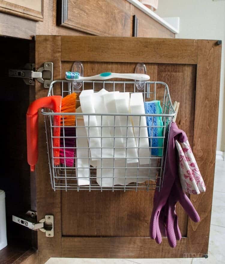 Hang Command Hooks to organize under the kitchen sink