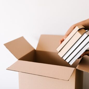 Books being put into a box.