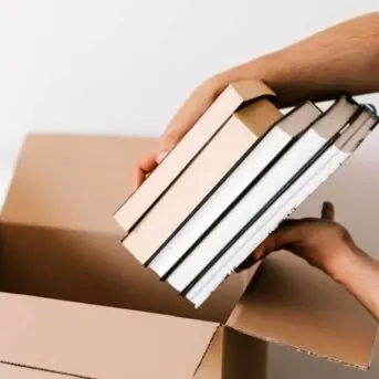 Books being put into a box.