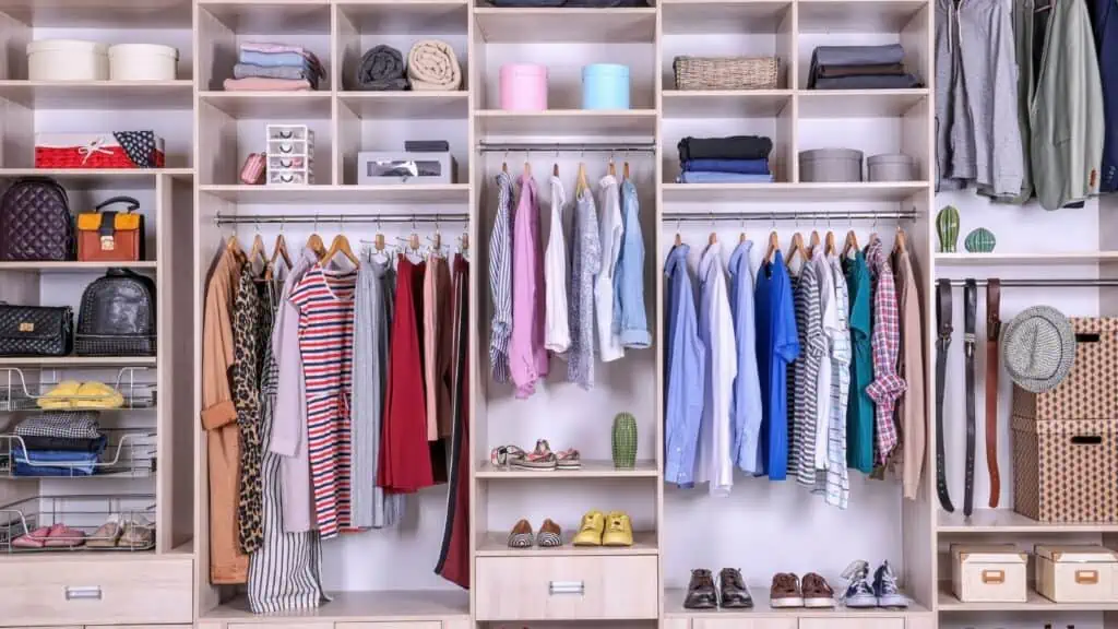 organized closet full of clothes and shoes