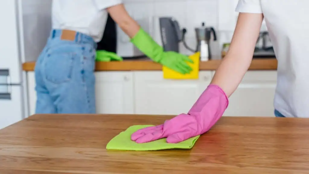 two people cleaning in bright rubber gloves