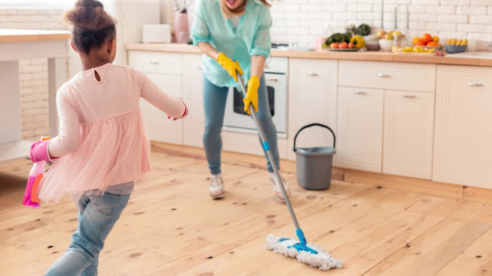 woman and child cleaning and playing