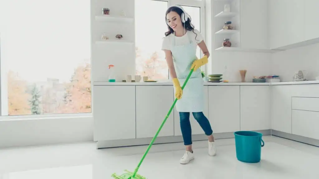 woman cleaning listening to music