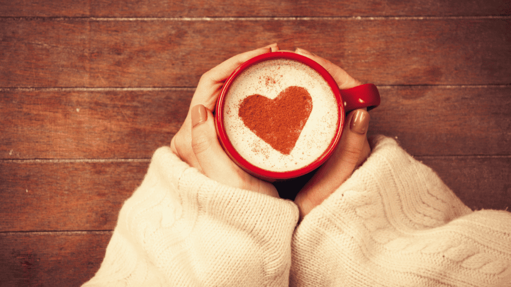 woman's hands woman holding coffee cup with heart