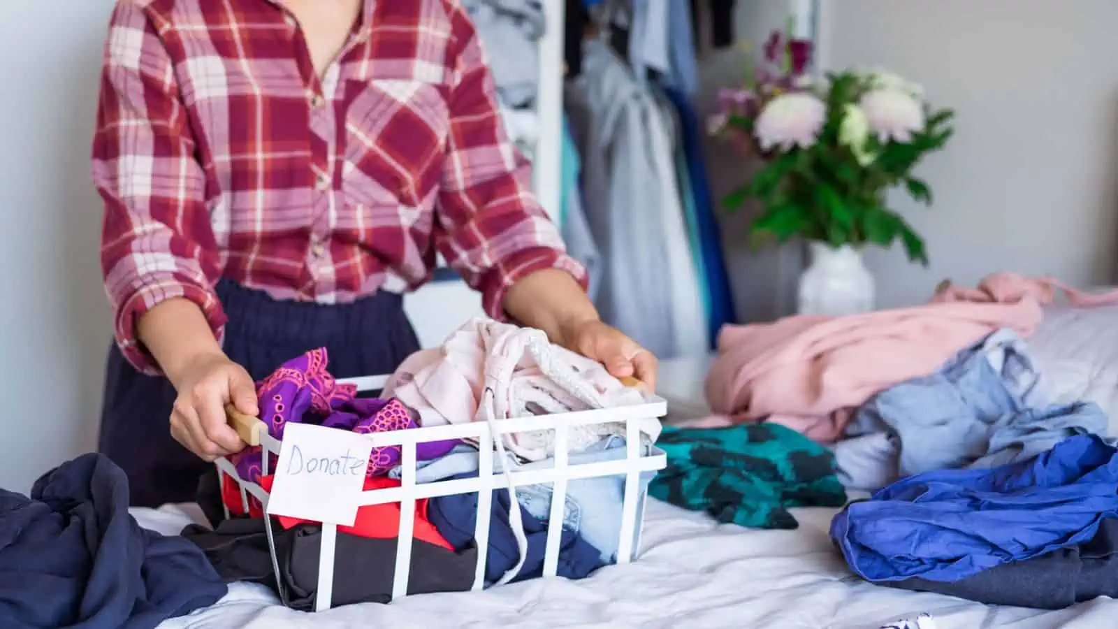 woman sorting clothing into decluttering pile