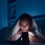 Woman starring mobile at night