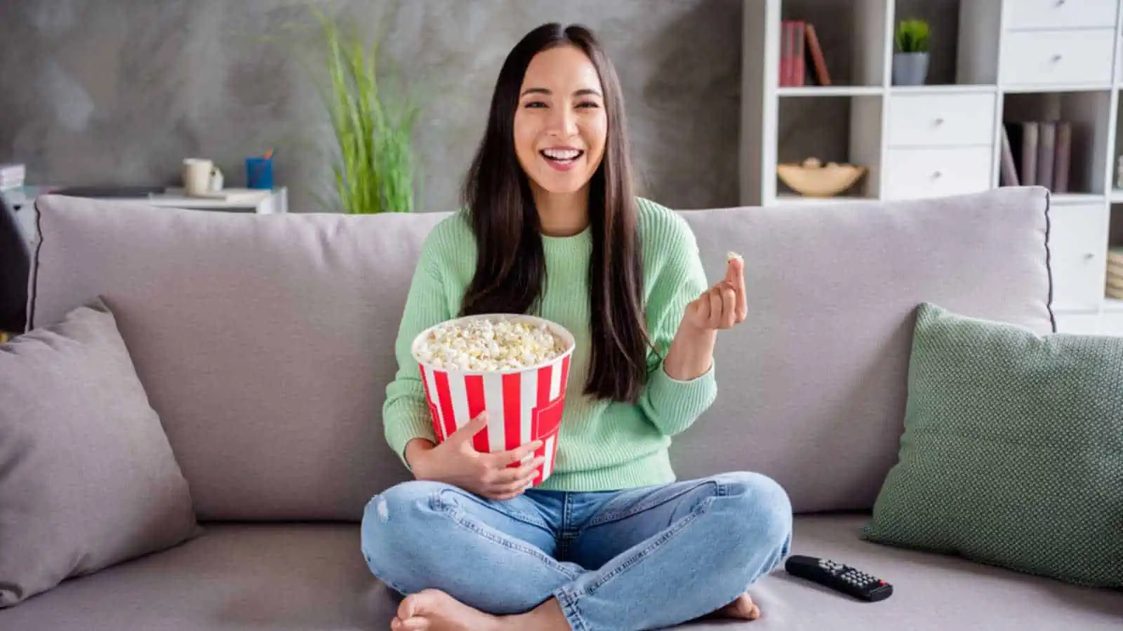 Woman with popcorn watching tv