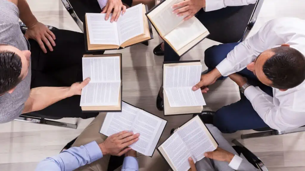 book club people sitting in circle holding books