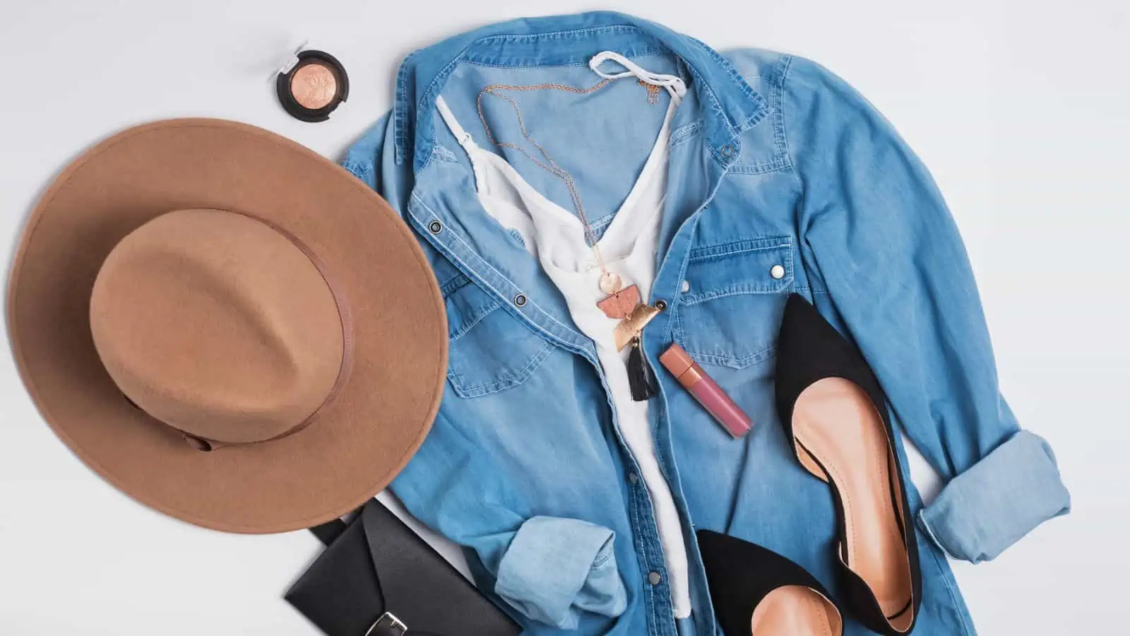 capsule wardrobe with denim shirt and brown hat