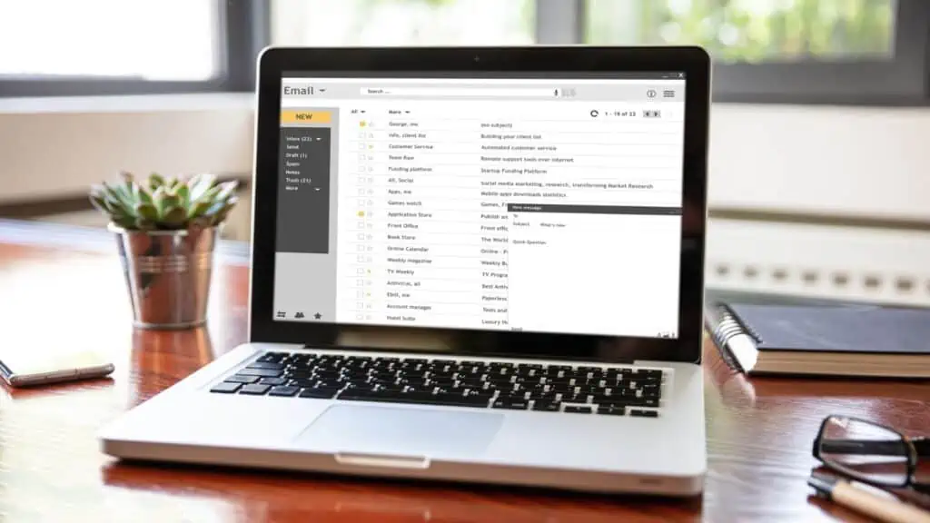 laptop on desk with email on screen