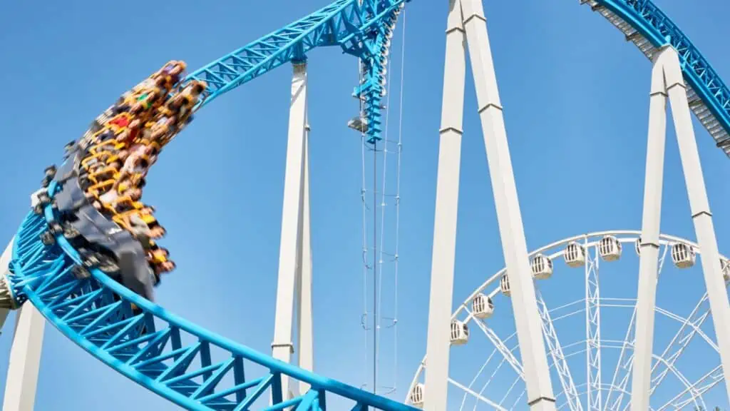 people riding blue rollercoaster