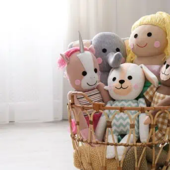 stuffed toys in basket on floor