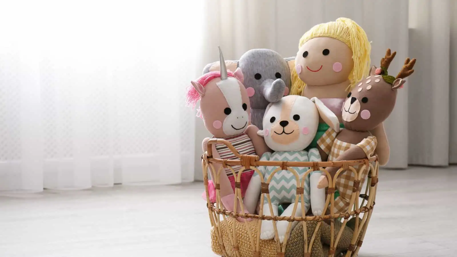 stuffed toys in basket on floor