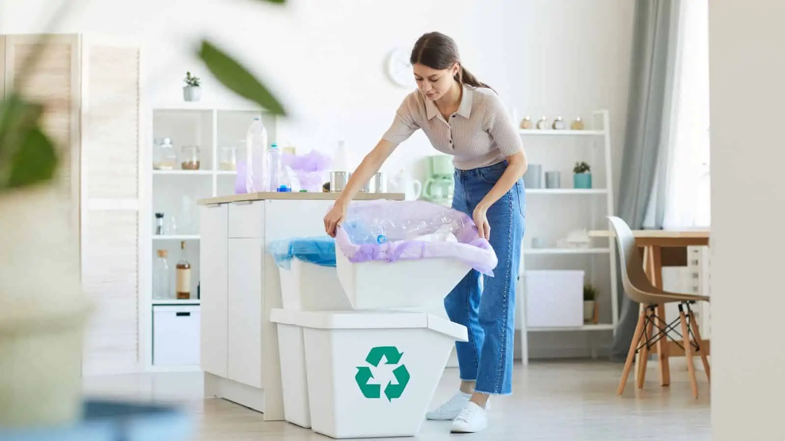 woman emptying trash and recycling