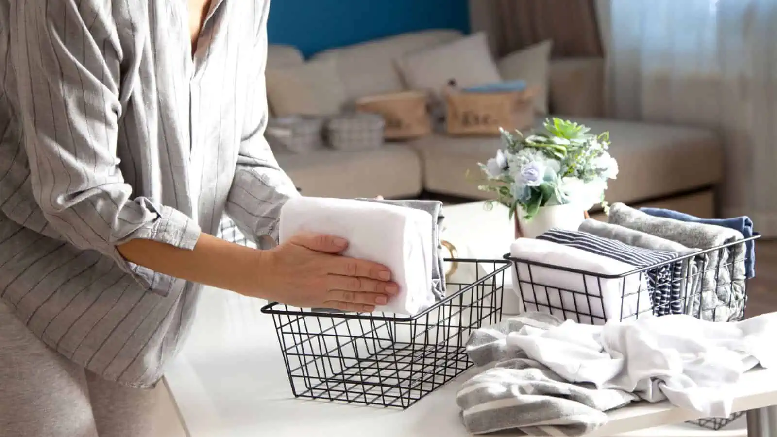 woman file folding towels and putting them into baskets