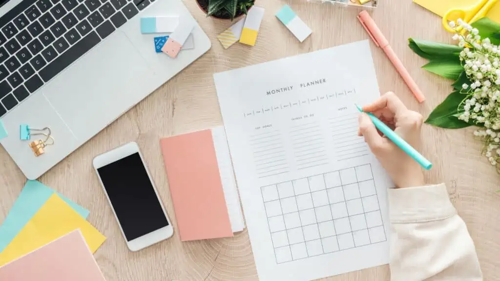 woman filling out planner