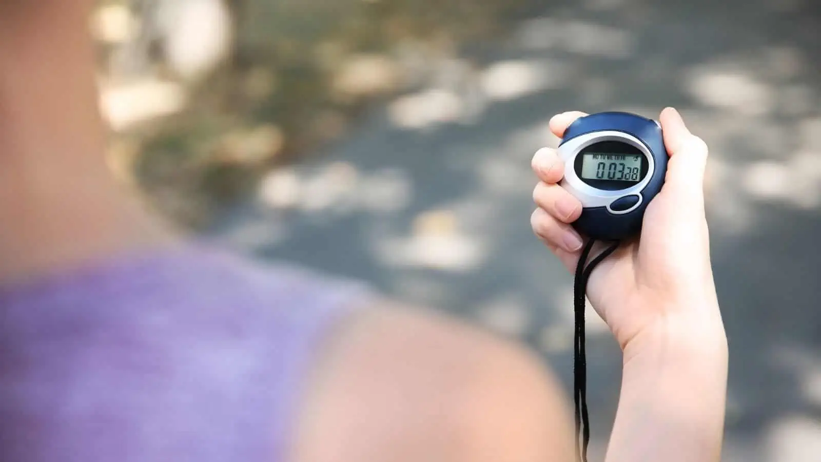 woman holding a stopwatch