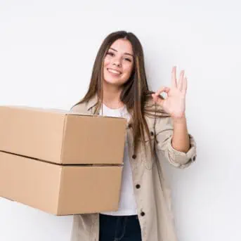 Young caucasian woman moving to a new home cheerful and confident showing ok gesture.