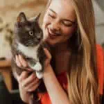 happy woman holding a cat