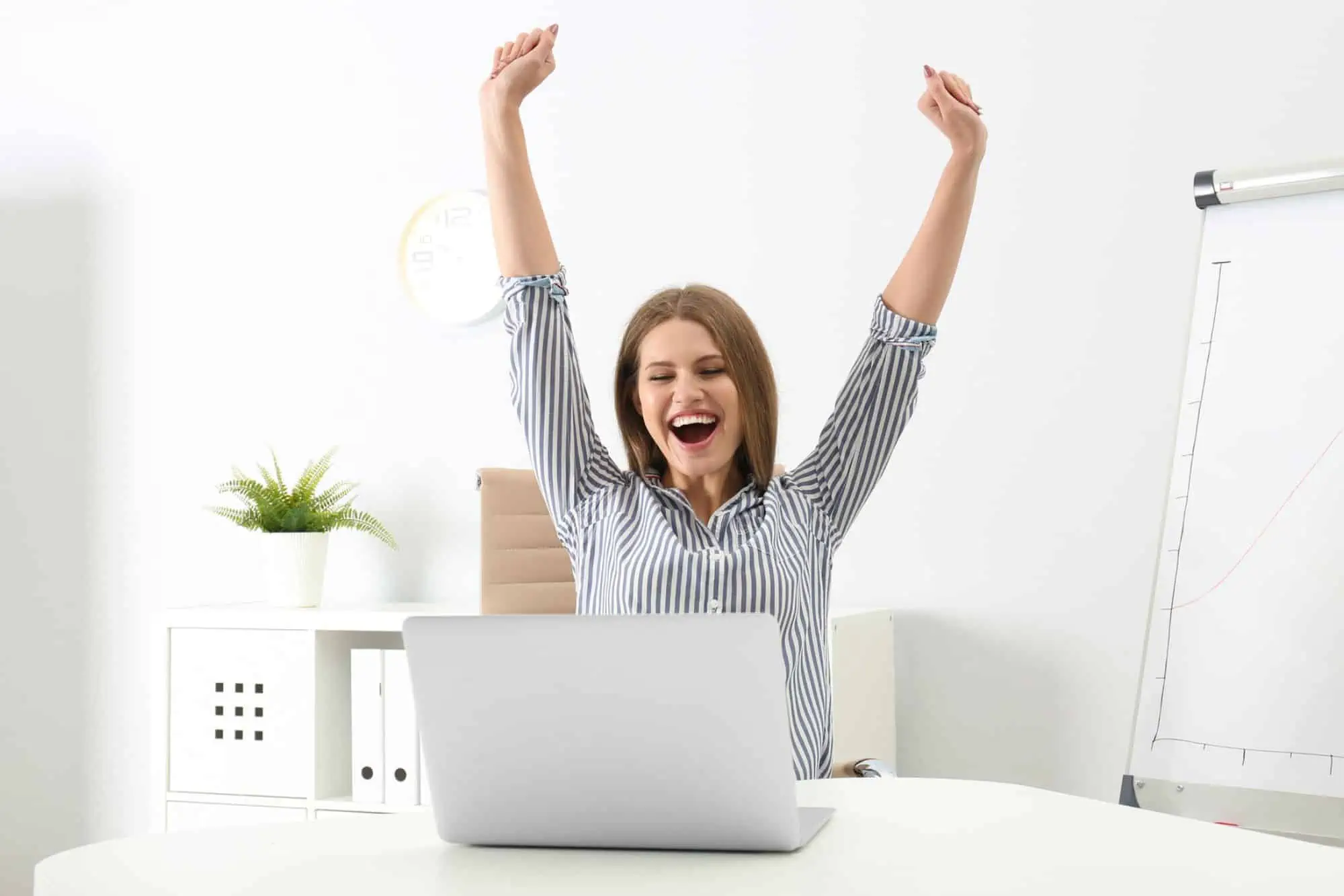 excited woman sitting at computer