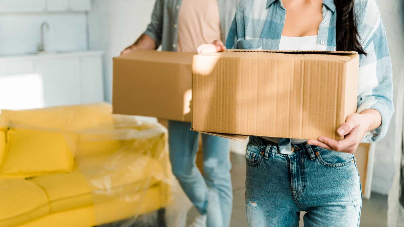 man and woman carrying boxes