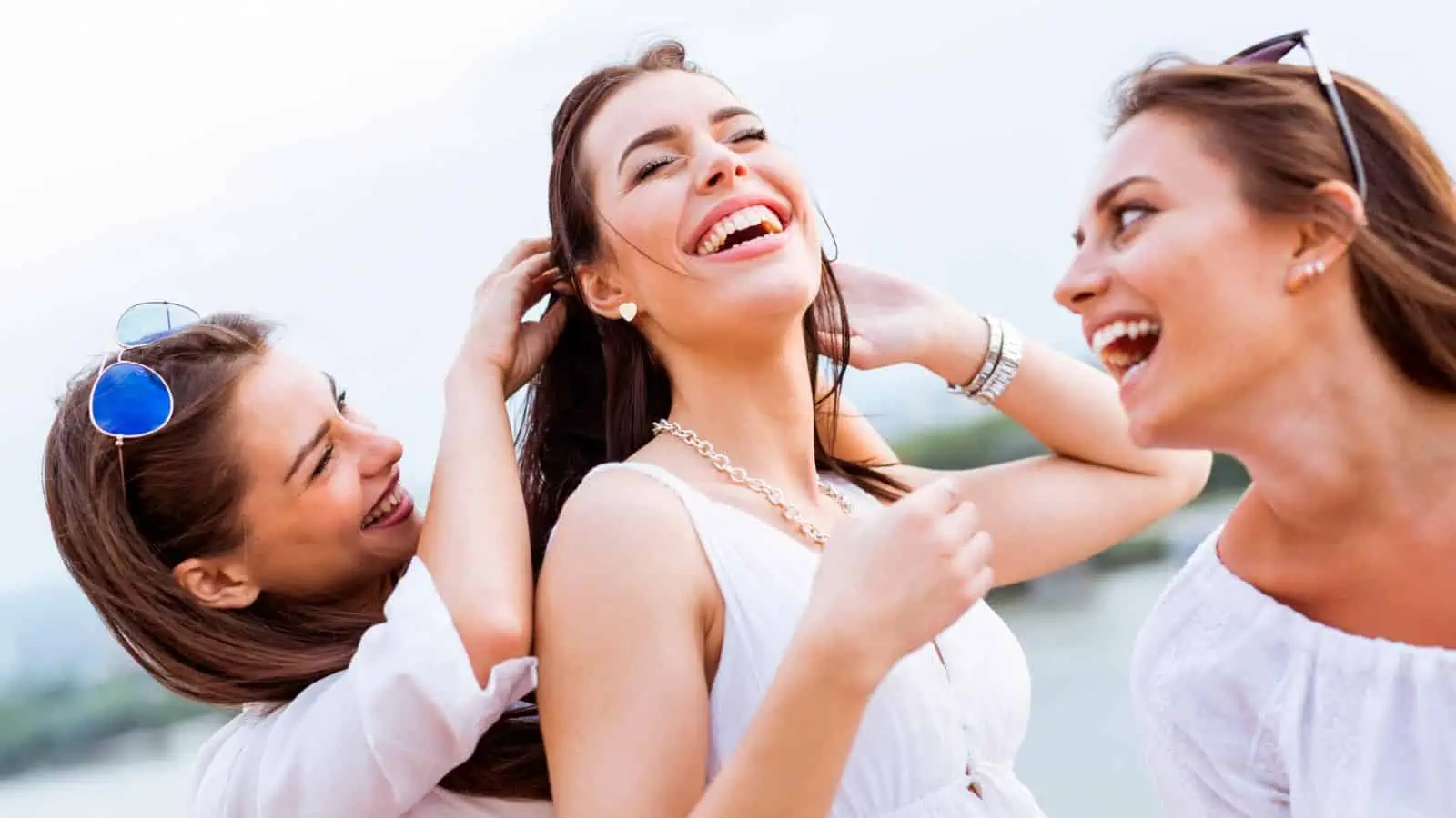 three women laughing together