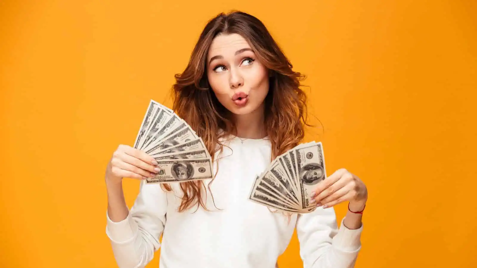 woman holding handfuls of money